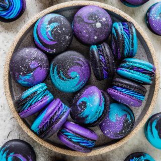 Galaxy Macarons purple, black, and blue macarons with silver shimmer.