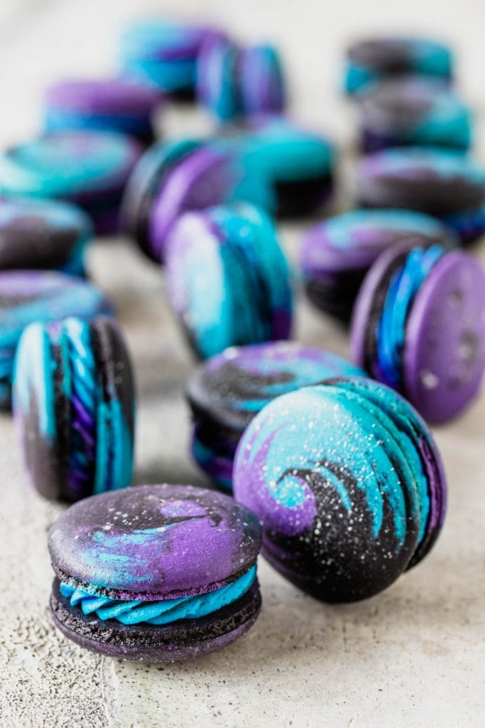 Galaxy Macarons purple, black, and blue macarons with silver shimmer.