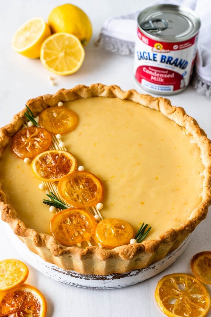 Lemon Pie with Condensed Milk topped with caramelized lemons and rosemary sprigs.