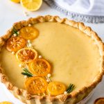 Lemon Pie with Condensed Milk topped with caramelized lemons and rosemary sprigs.