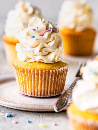vanilla cupcakes topped with sprinkles.