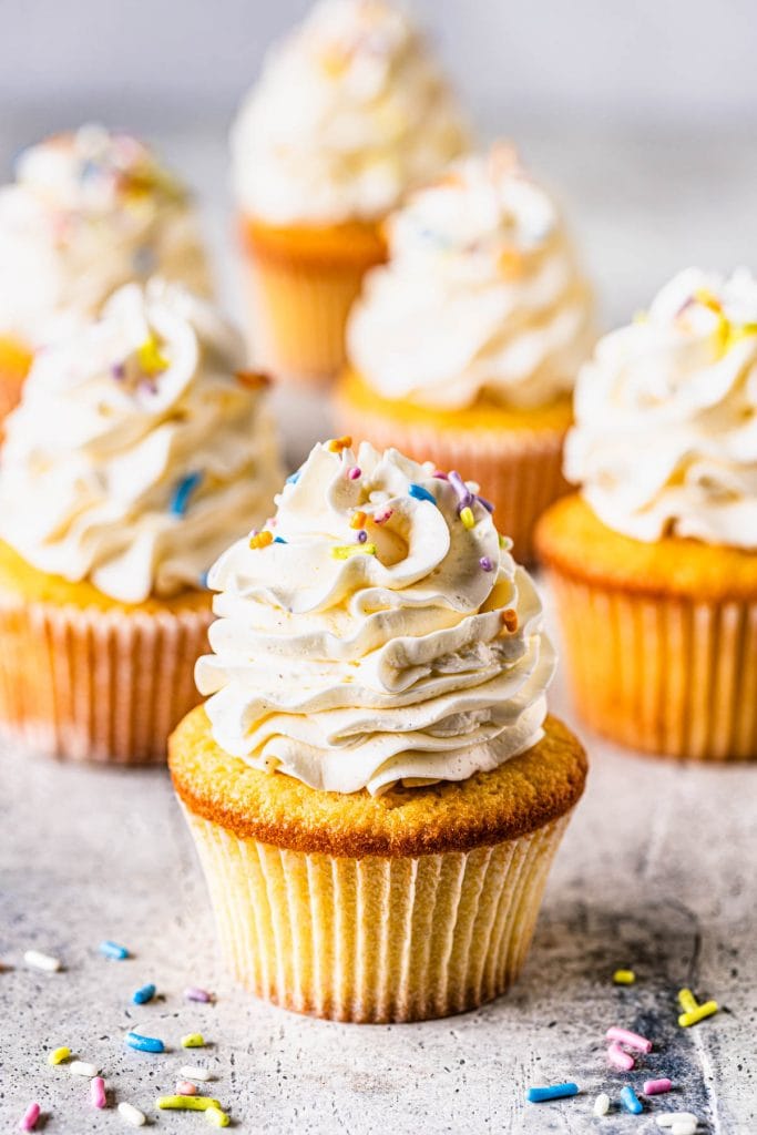 vanilla cupcakes topped with sprinkles.