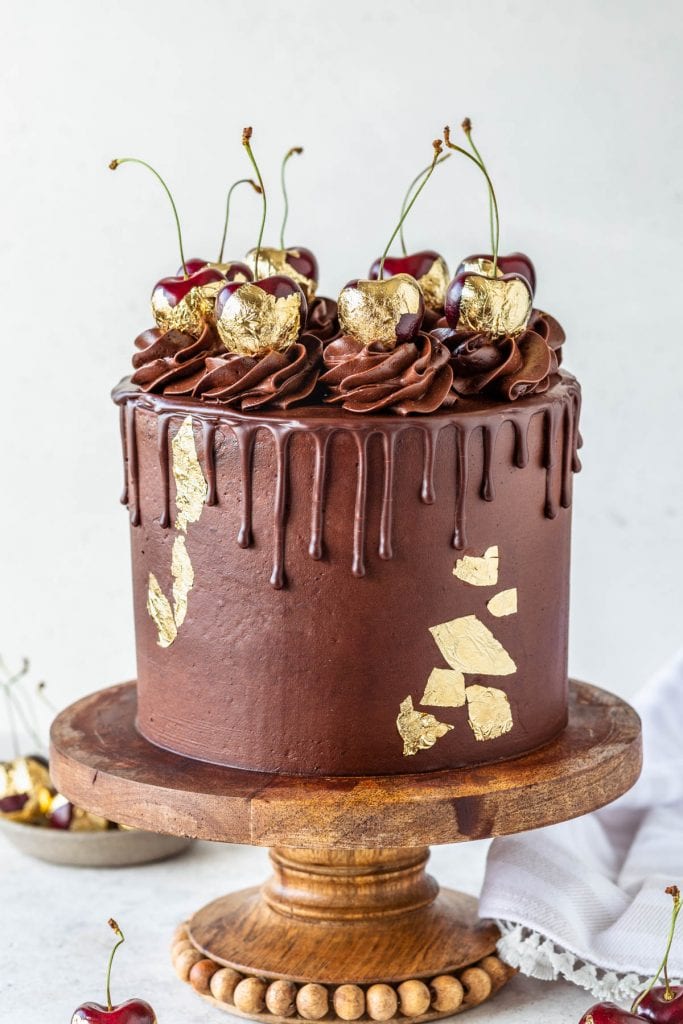 Chocolate Cherry Cake topped with chocolate pudding frosting and gold cherries