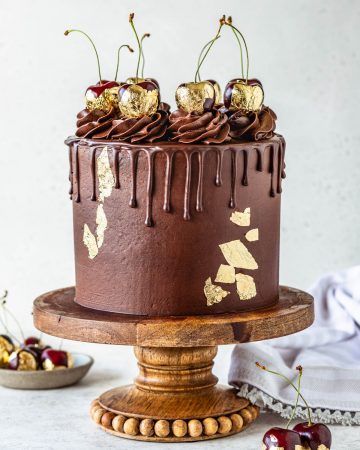 Chocolate Cherry Cake topped with chocolate pudding frosting and gold cherries