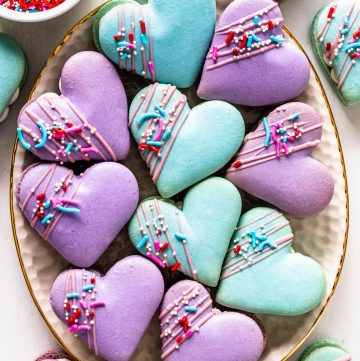 Heart Macarons filled with brownie, decorated with sprinkles and melted chocolate.