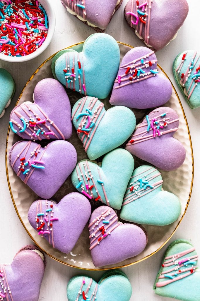 Heart Macarons filled with brownie, decorated with sprinkles and melted chocolate.