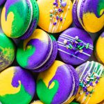 purple, green and yellow macarons topped with sprinkles for mardi gras.