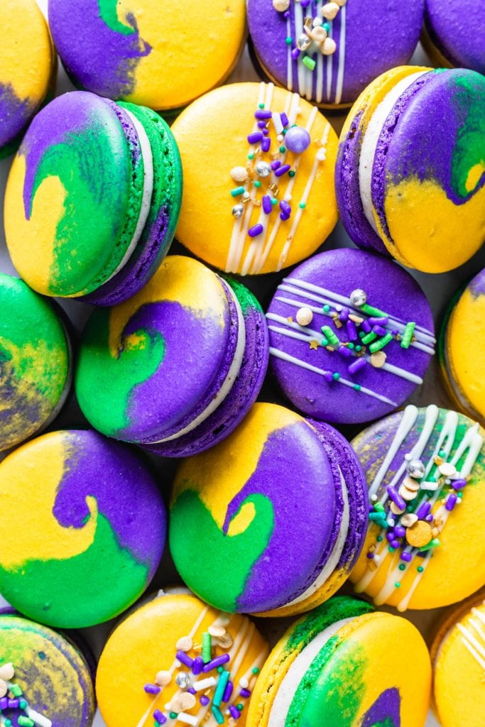 purple, green and yellow macarons topped with sprinkles for mardi gras.