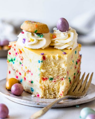 funfetti cheesecake topped with cookies and chocolate eggs.