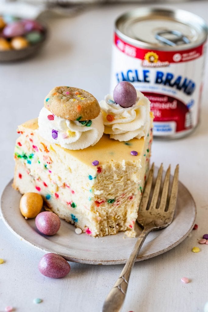 funfetti cheesecake topped with cookies and chocolate eggs.