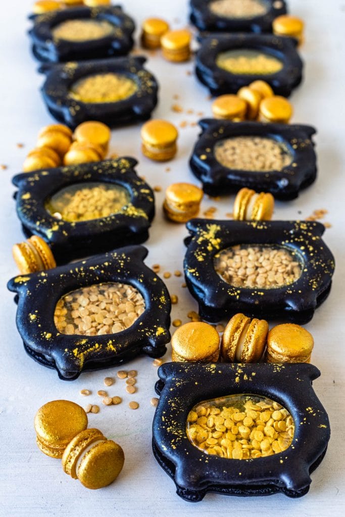 macarons shaped like pots of gold, filled with gold sprinkle coins, and with mini gold macarons.