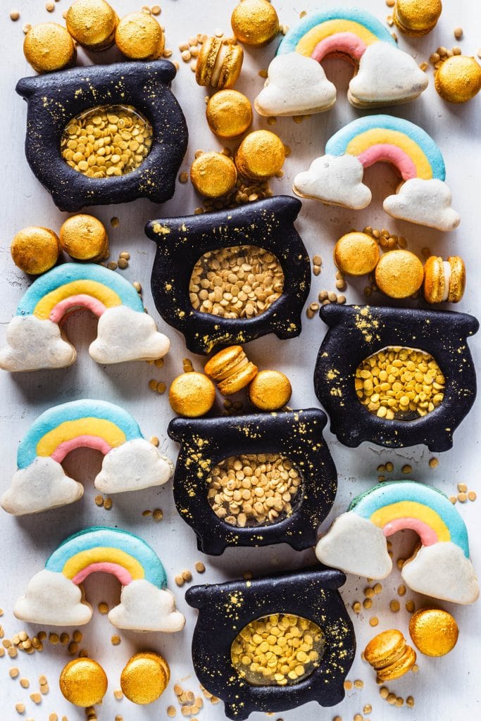 rainbow macarons and macarons shaped like pots of gold, filled with gold sprinkle coins, and with mini gold macarons.
