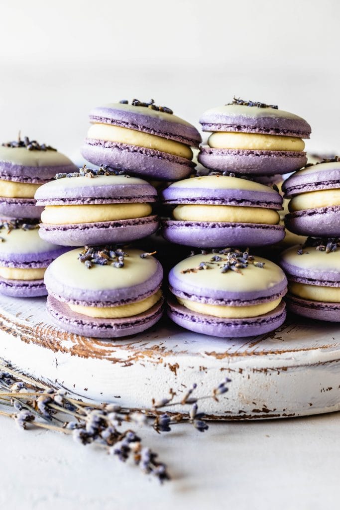 Lavender Macarons dipped in white chocolate and topped with lavender buds.