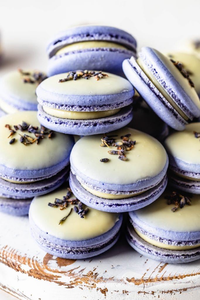 Lavender Macarons dipped in white chocolate and topped with lavender buds.