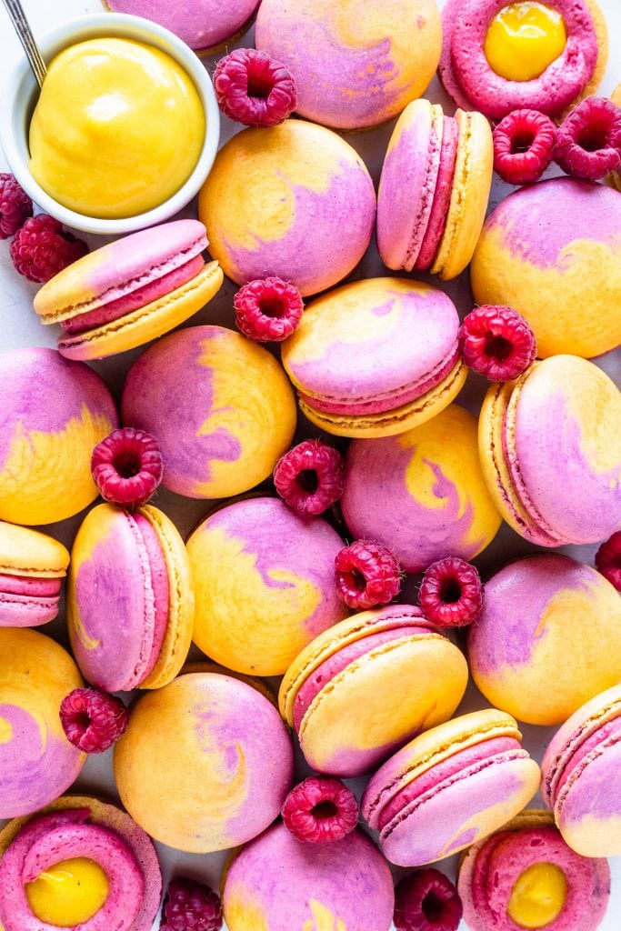 Mango Raspberry Macarons with bicolor shells pink and yellow.