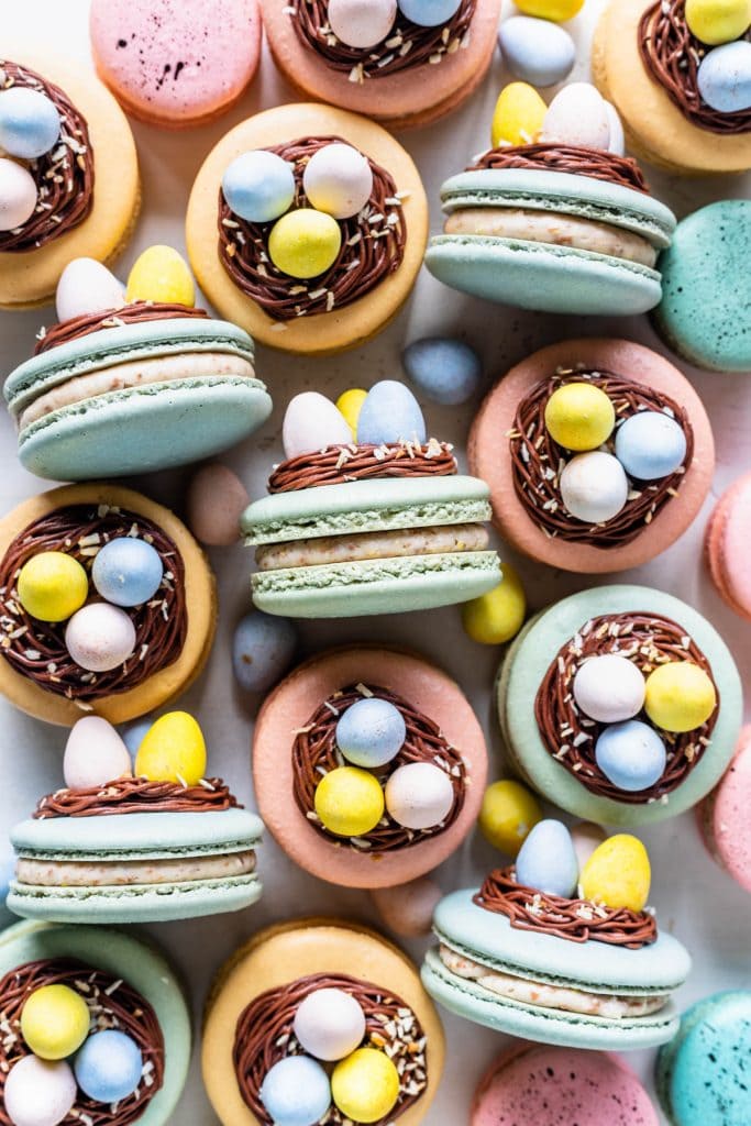 macarons topped with a nest made out of chocolate frosting, and cadbury eggs.