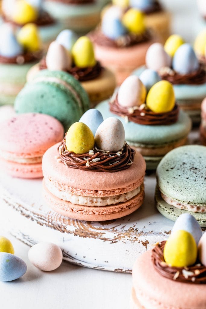 macarons topped with a nest made out of chocolate frosting, and cadbury eggs.