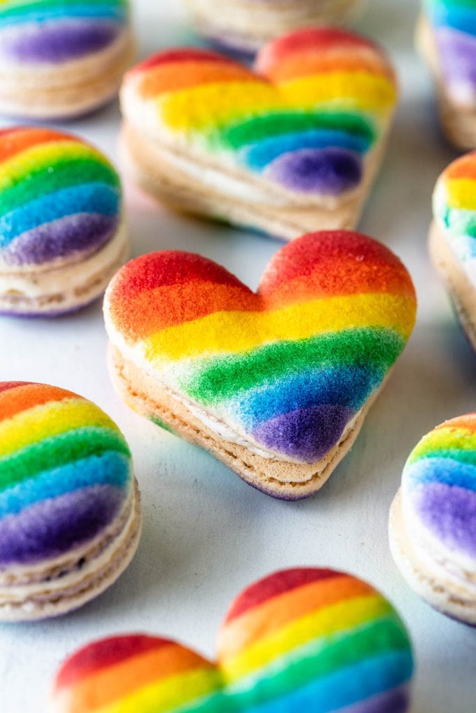 pride macarons, heart and circle shaped macarons with a rainbow decoration.