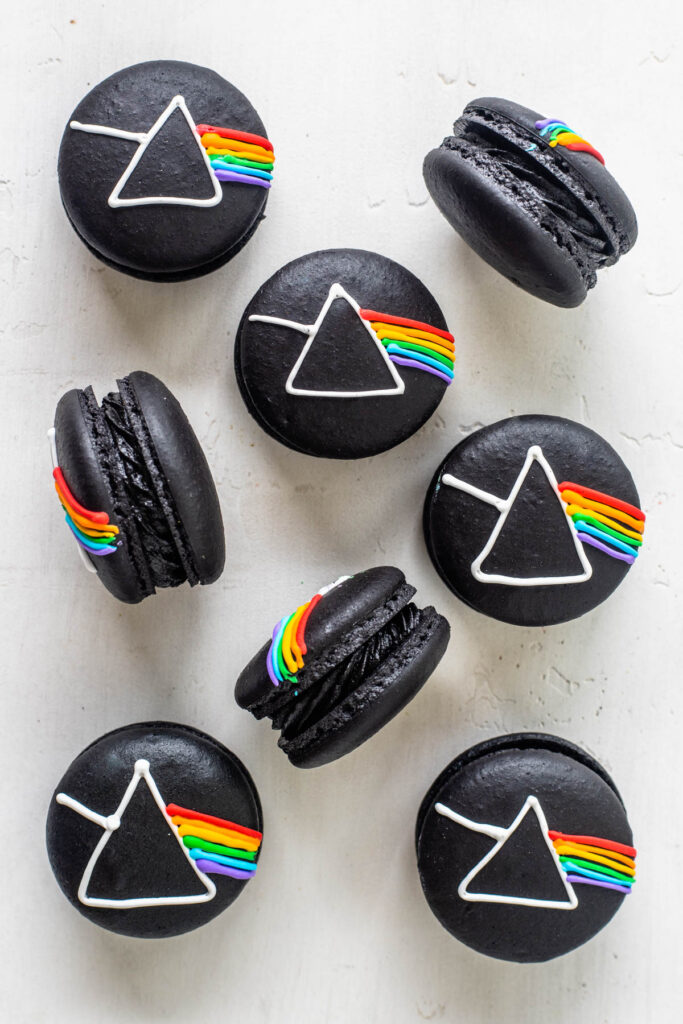 Pink Floyd Macarons, black macarons with the pink floyd logo drawn on top with royal icing.