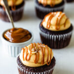 chocolate cupcakes topped with dulce de leche cream cheese frosting, a drizzle of dulce de leche, and coarse sea salt.