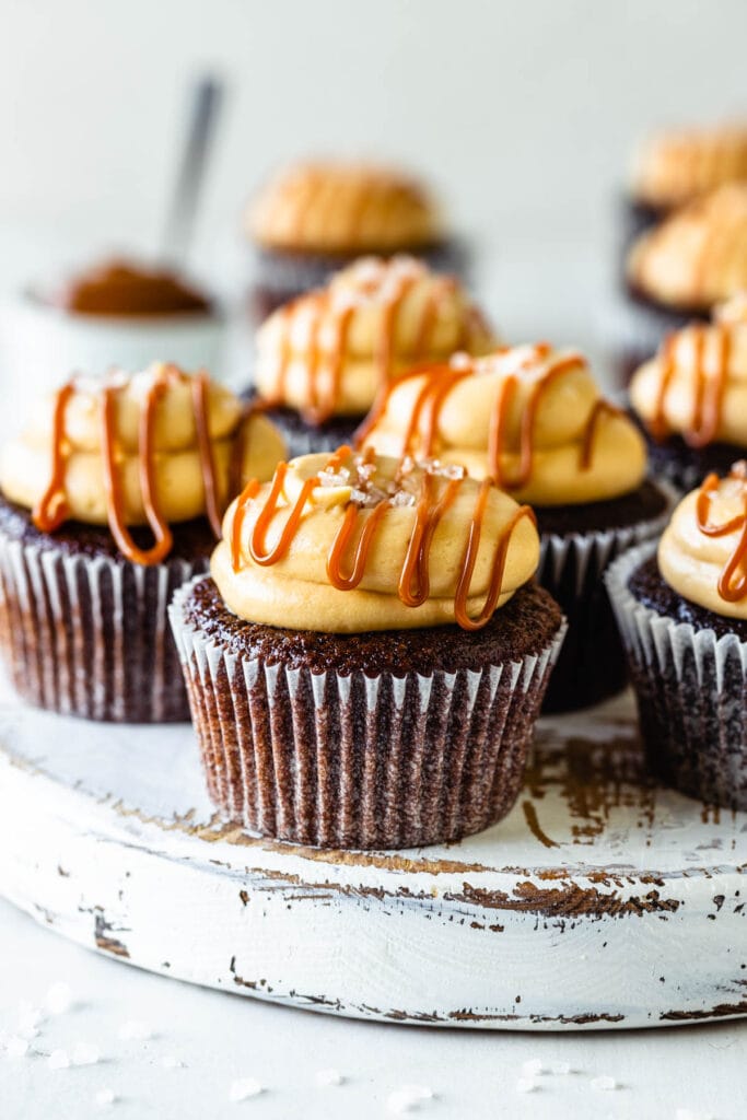 chocolate cupcakes topped with dulce de leche cream cheese frosting, a drizzle of dulce de leche, and coarse sea salt.