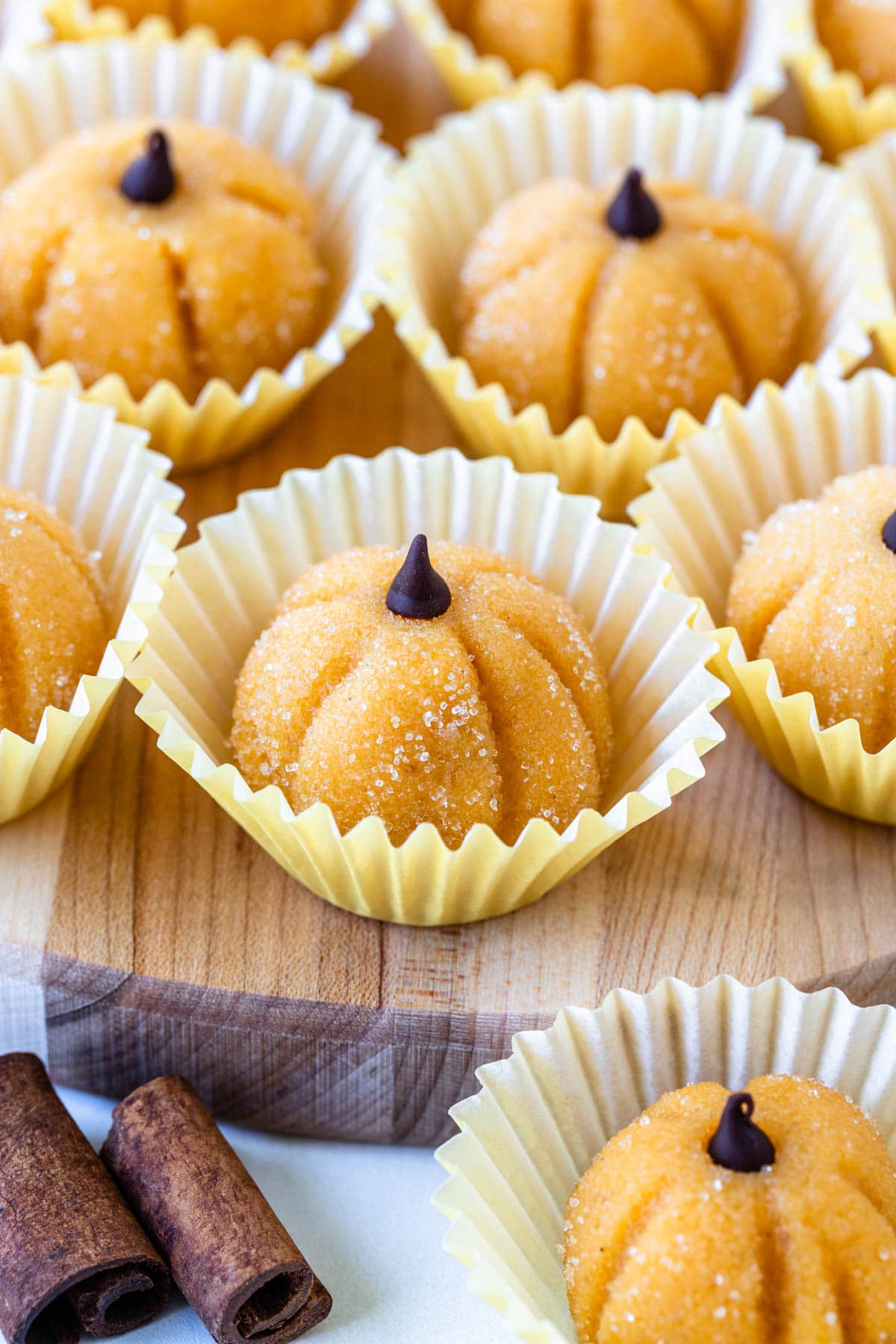 pumpkin brigadeiros with a chocolate chip on top.