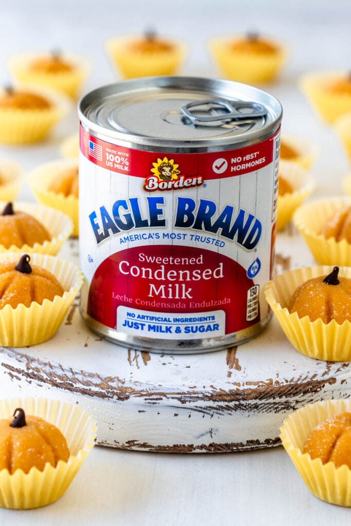 can of eagle brand sweetened condensed milk with pumpkin brigadeiros.