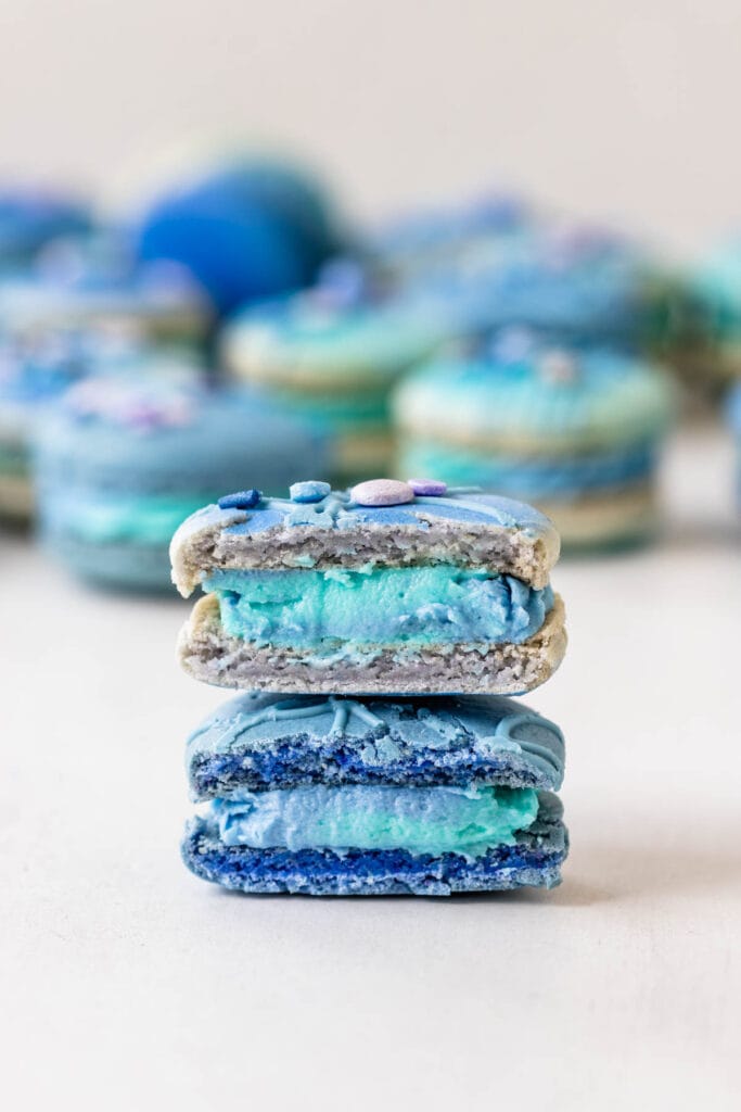 macarons sliced in half with blue filling.