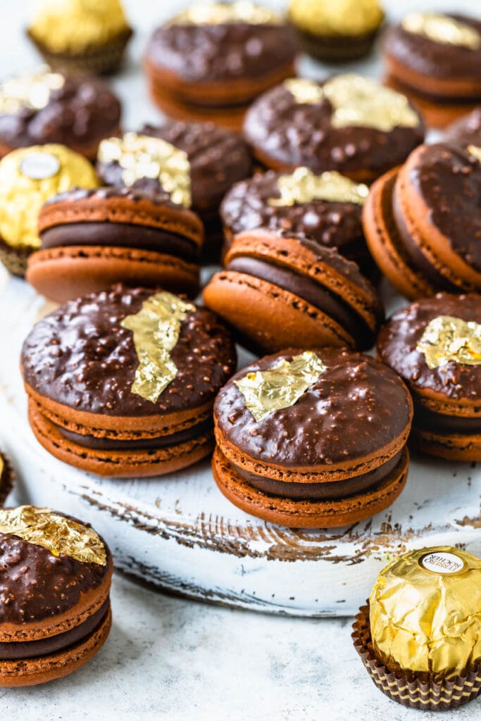 ferrero rocher macarons filled with ganache and decorated with gold leaves.