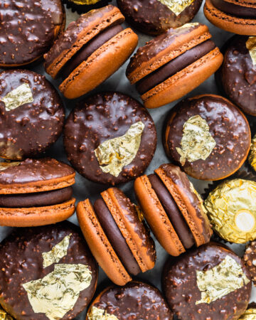 ferrero rocher macarons filled with ganache and decorated with gold leaves.