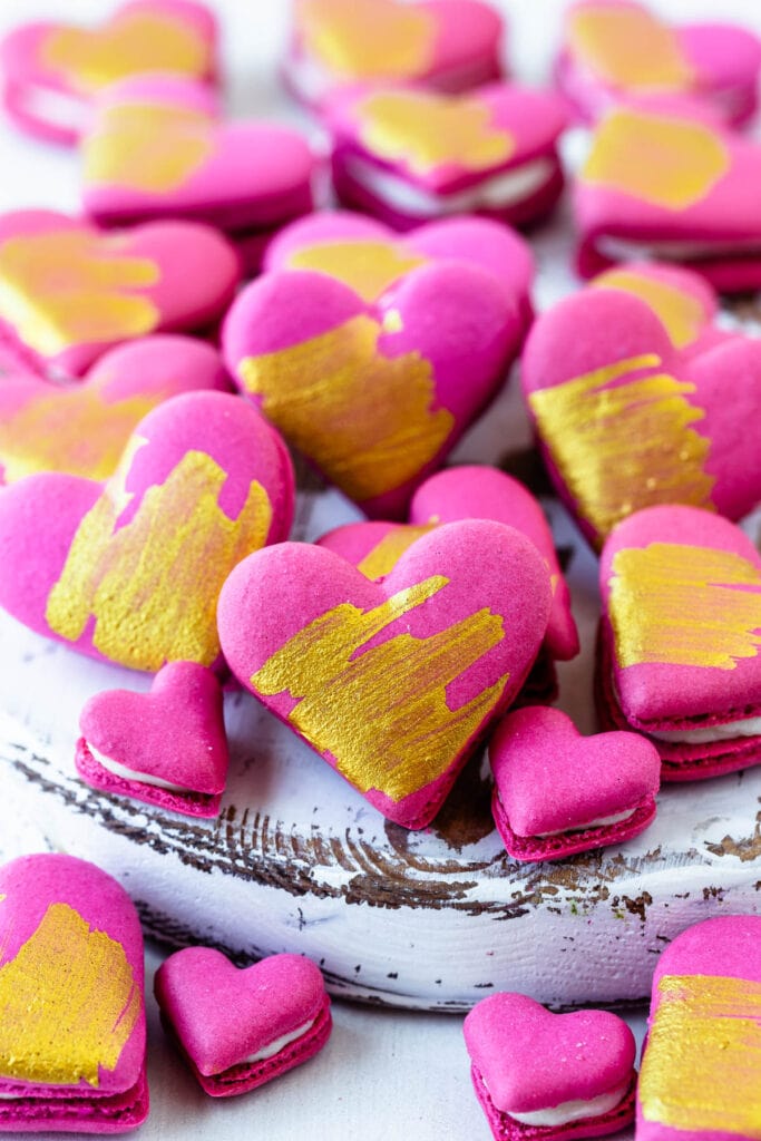 heart macarons with a golden brush.