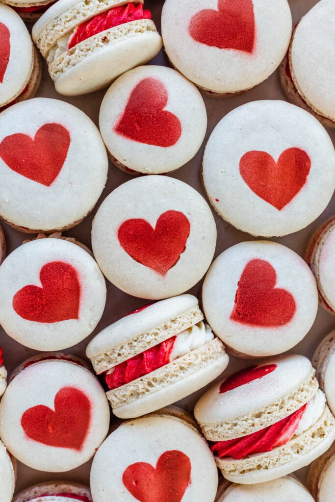 macarons with all-purpose flour and a heart on top, and bicolor red and white frosting in the middle.