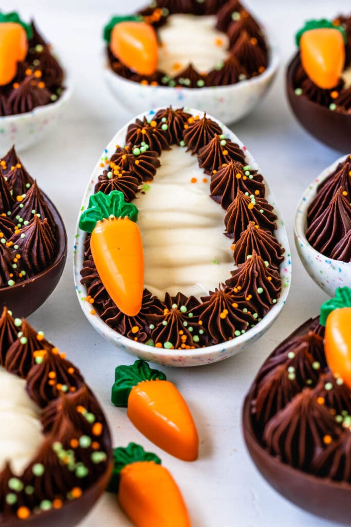 Cheesecake filled easter eggs decorated with ganache and carrots.