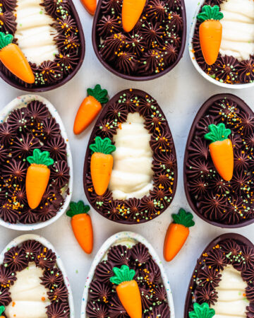 Cheesecake filled easter eggs decorated with ganache and carrots.