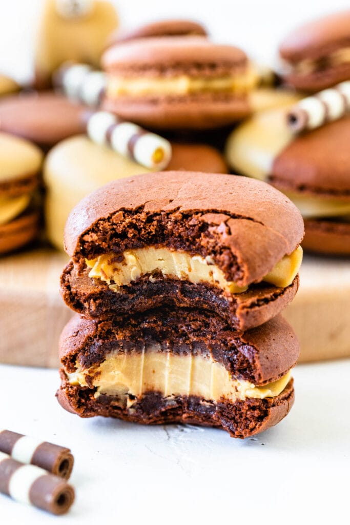 two macarons filled with caramelized white chocolate ganache bitten