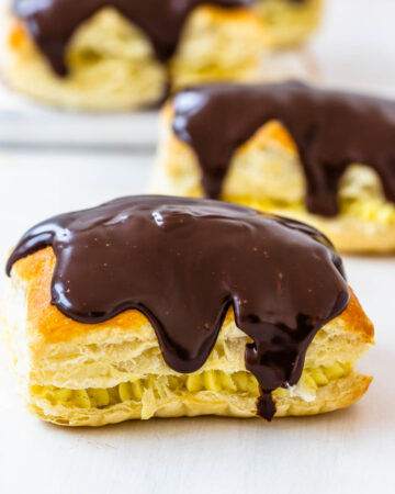 boston cream pastry, drizzled with chocolate on top.