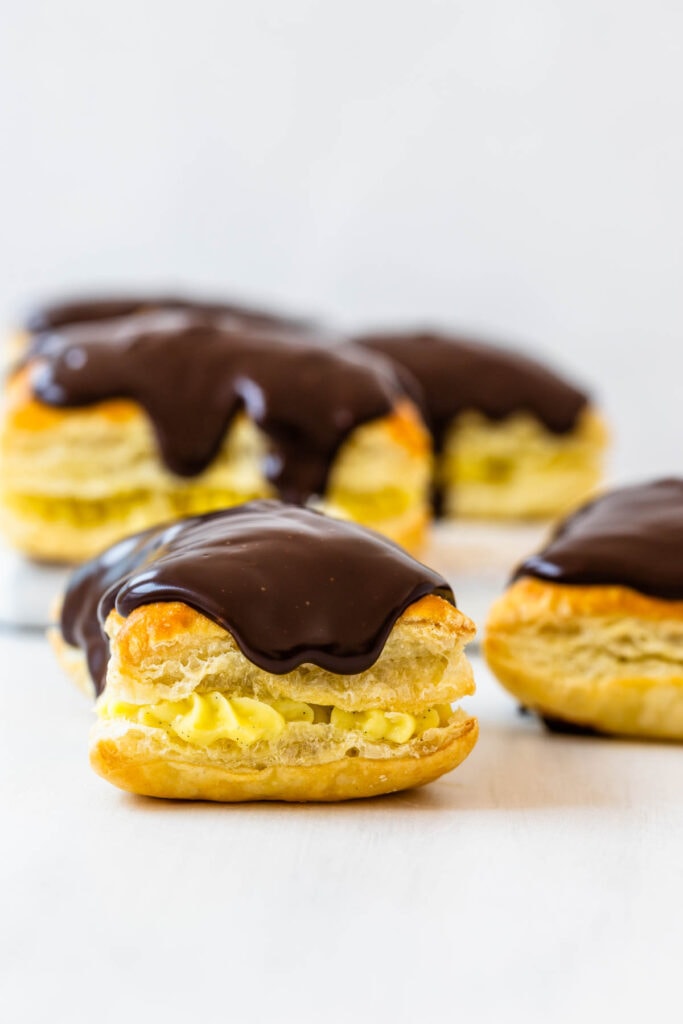 boston cream pastry, drizzled with chocolate on top.