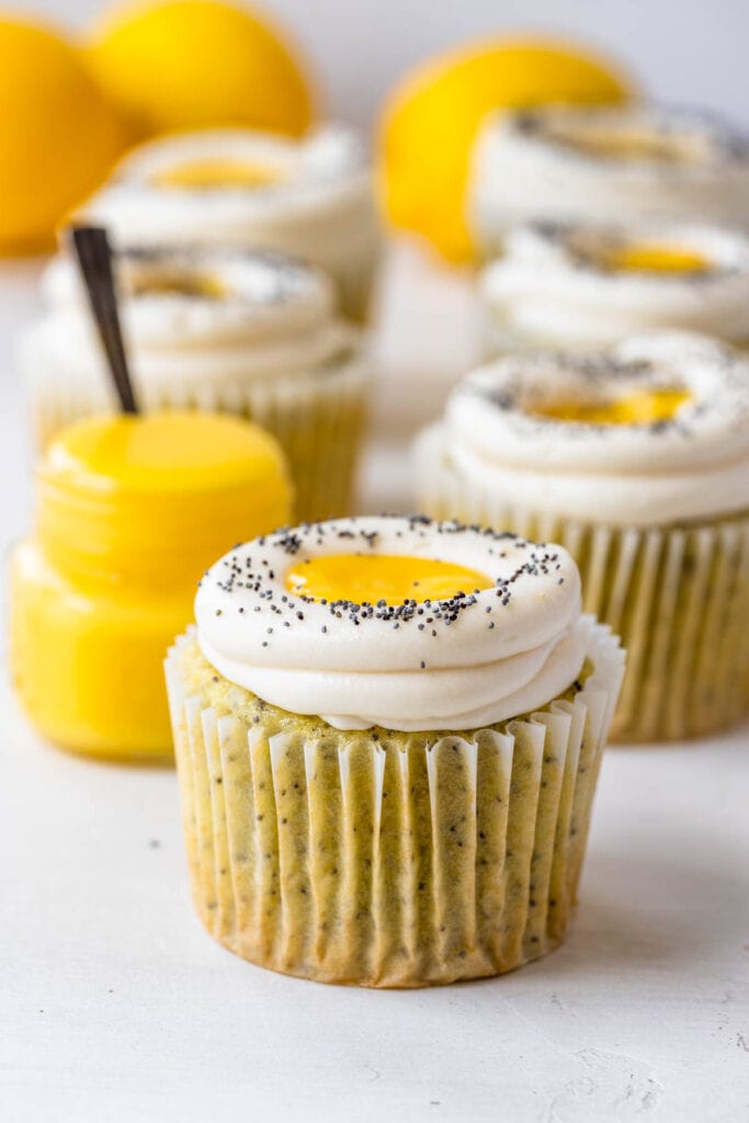 Lemon poppy seed cupcakes filled with lemon curd topped with cream cheese frosting and poppy seeds.