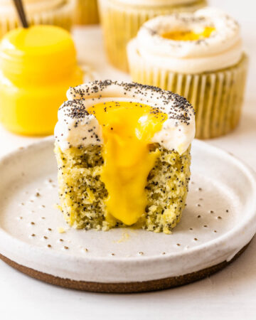 Lemon poppy seed cupcakes filled with lemon curd topped with cream cheese frosting and poppy seeds.