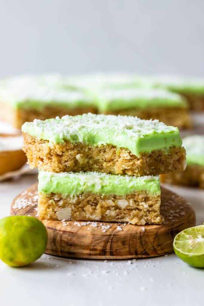 Lime frosted coconut bars topped with a green frosting.