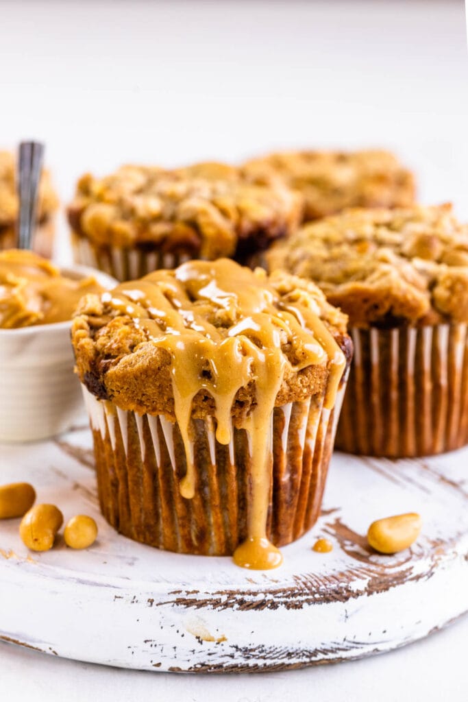 peanut butter banana muffins with peanut butter glaze on top.
