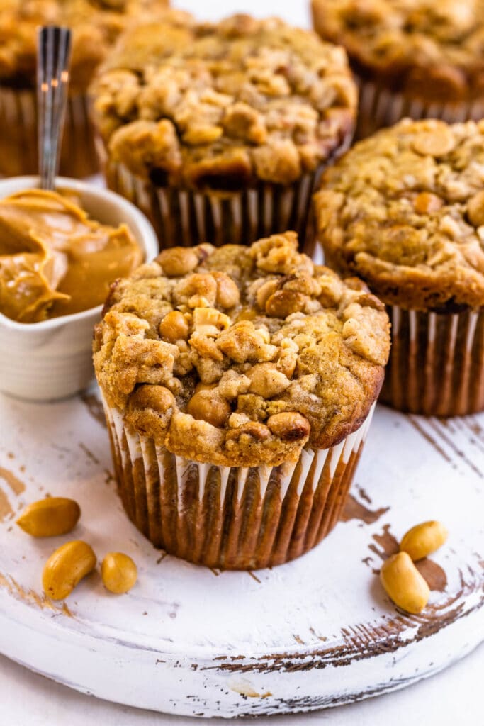 peanut butter banana muffins with peanut butter glaze on top.
