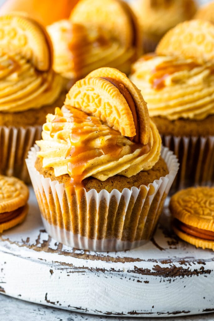 brown butter pumpkin cupcakes with caramel on top and an oreo.