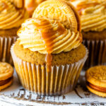 brown butter pumpkin cupcakes with caramel on top and an oreo.