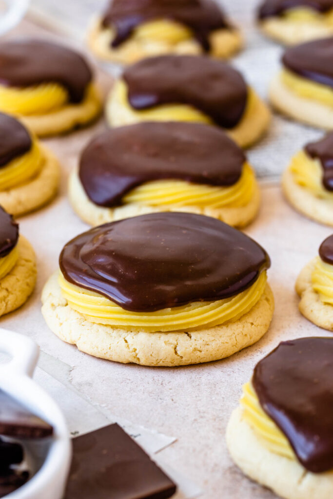 boston cream cookies, sugar cookies topped with pastry cream and chocolate glaze.