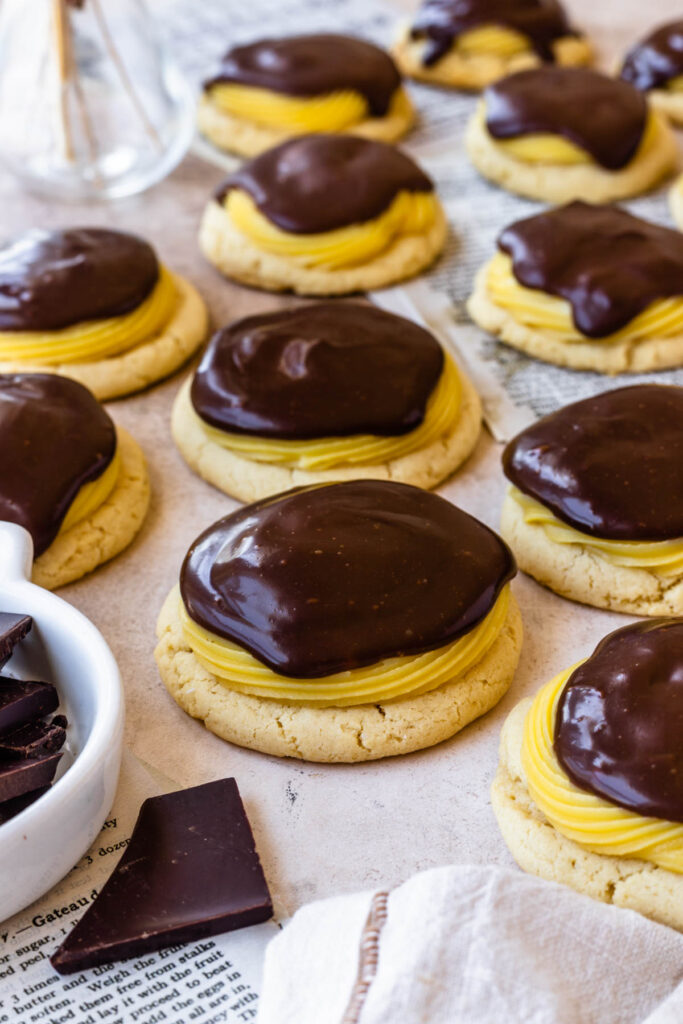 boston cream cookies, sugar cookies topped with pastry cream and chocolate glaze.