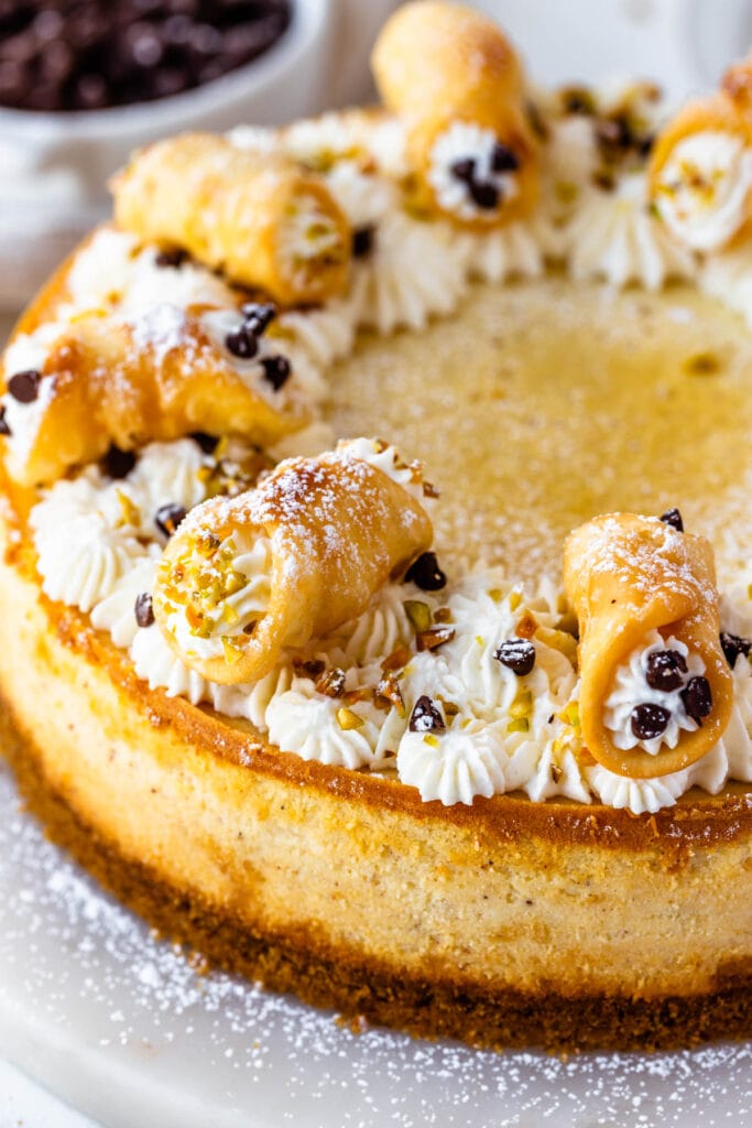 Cannoli cheesecake topped with mini cannoli.