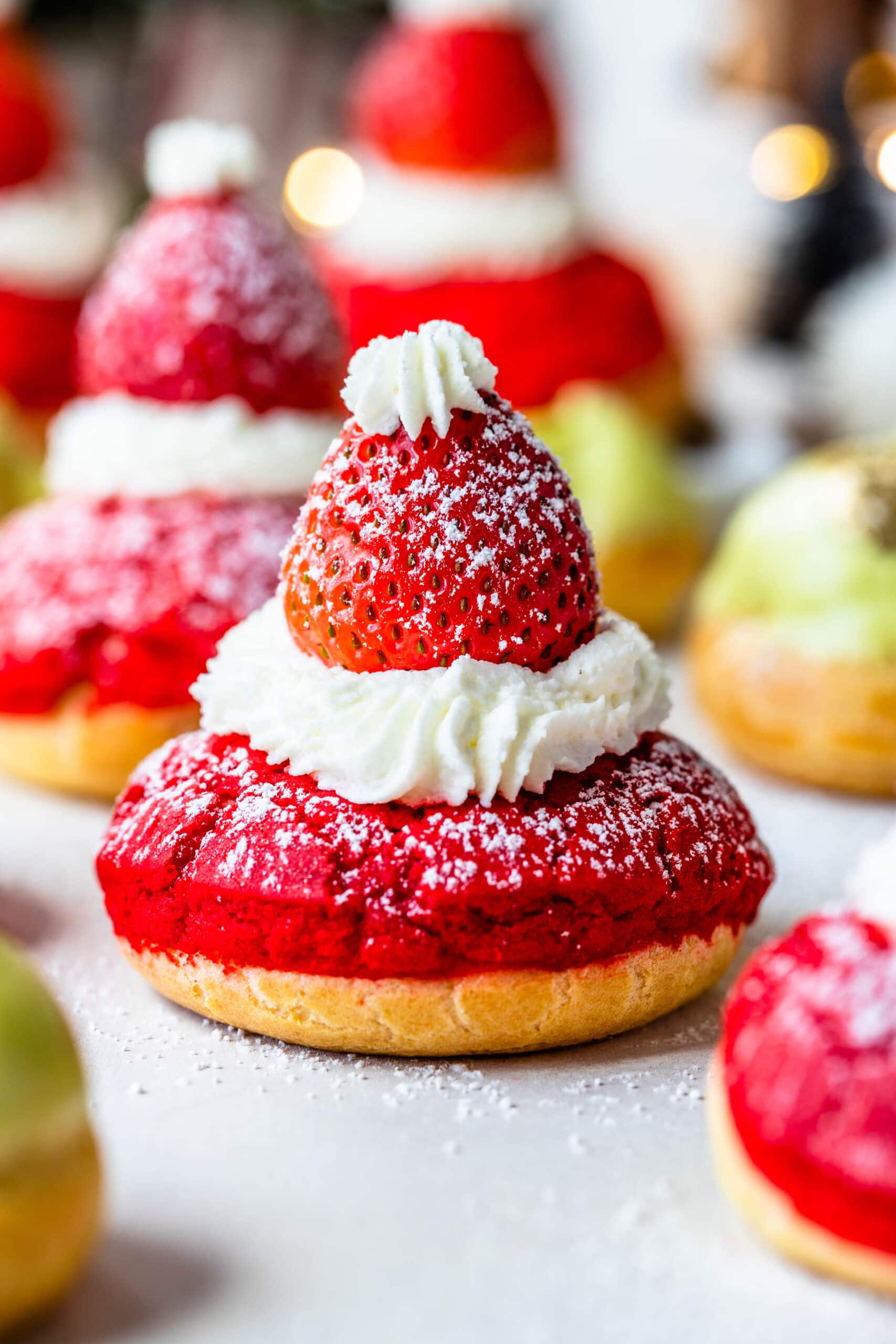 Christmas puffs looking like santa claus with a strawberry on top