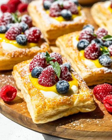 Puff pastry baked and filled with mascarpone cheese frosting and lemon curd, topped with berries.