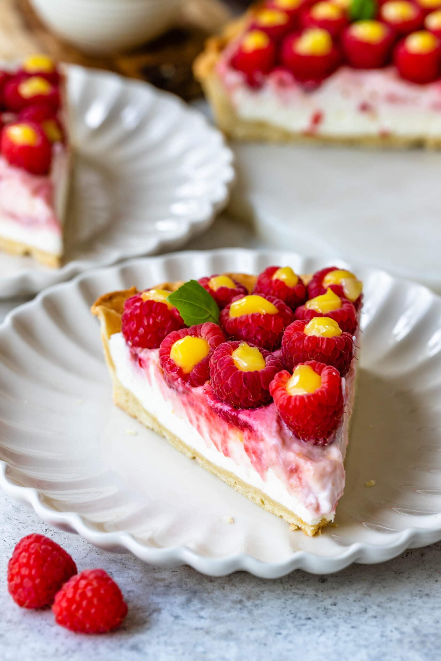 slice of raspberry lemon pie, topped with raspberries.